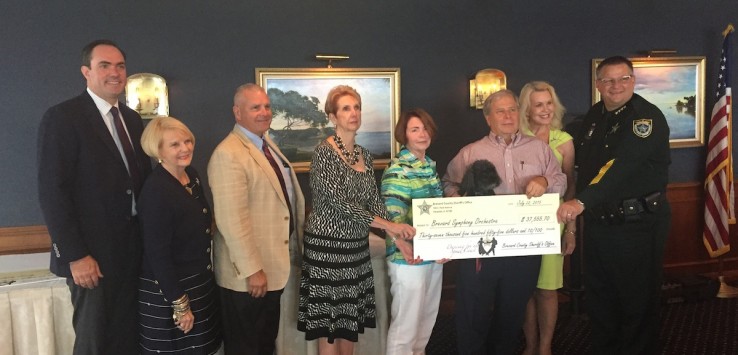 Brevard Symphony Orchestra board of directors receiving check from Brevard Sheriff Wayne Ivey. Photo by Pam Harbaugh