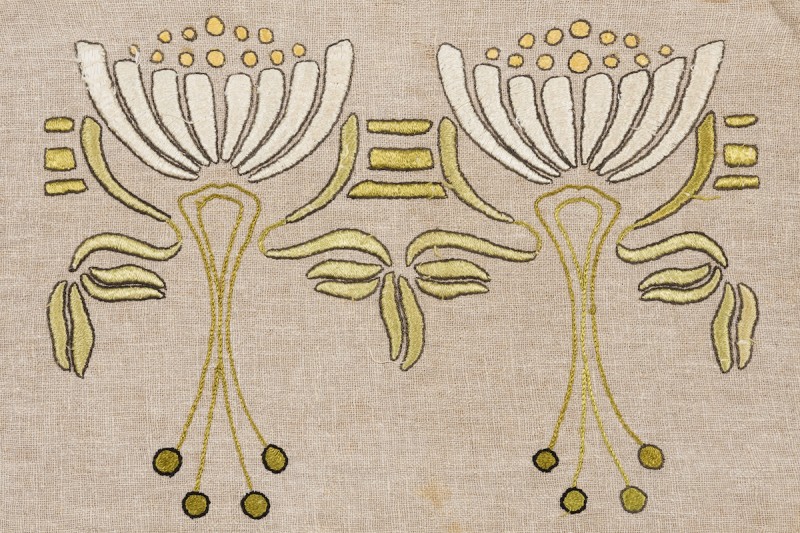 From FLORA & FIBER at the Ruth Funk Center for Textile Arts. Pillow cover (detail), United States, c. 1910. Linen, plain woven, chain stitch, satin-embroidered. Gift of Marilynn Johnson, 2006.02.01. Photo by Dominic Agostini